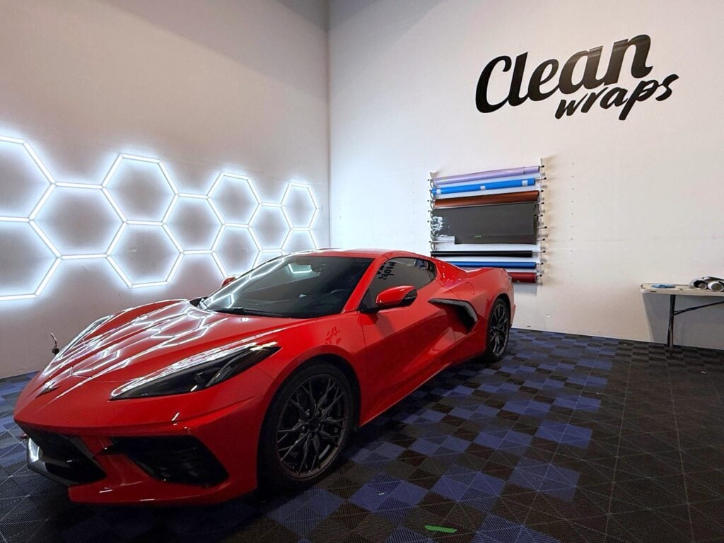 The Clean Wraps shop in American Fork with a red sports car and vinyl wrap rolls